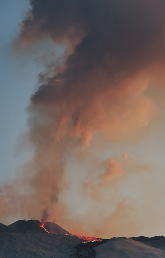 a romantic shot of mount etna erupting with a column of pink smoke in the sky